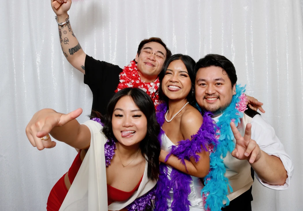 Friends in leis and feather boas